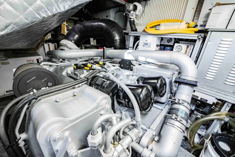 Slide: The Image of Engine room of a 2017 Pershing 70 yacht, showcasing complex machinery and components. - 45
