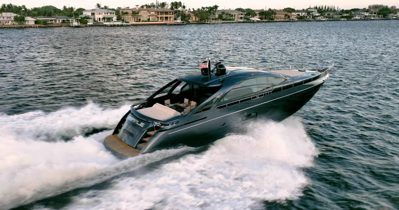 Slide: The Image of 2017 Pershing 70 yacht cruising on a scenic waterway near luxury homes. - 49