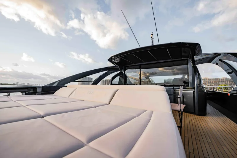 Slide: The Image of Luxurious 2017 Pershing 70 yacht with sleek design and spacious deck under a cloudy sky. - 8