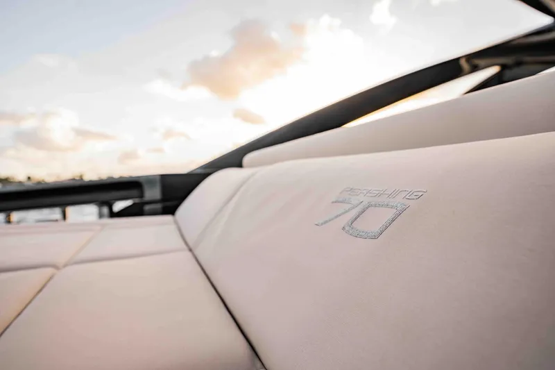 Slide: The Image of Luxurious seating on a 2017 Pershing 70 yacht with sunset backdrop. - 9