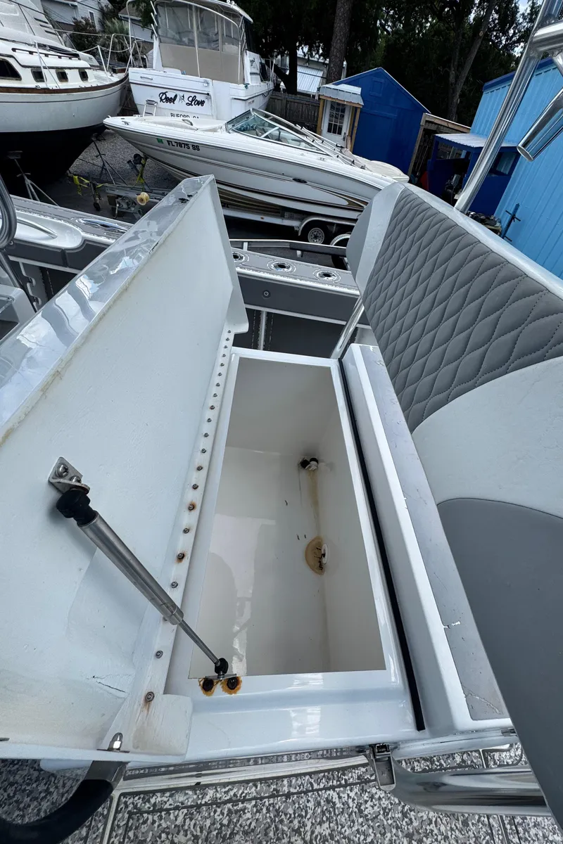 Slide: The Image of 2022 Twin Vee 310 CC GF Classic boat storage compartment open, showcasing interior space. - 10