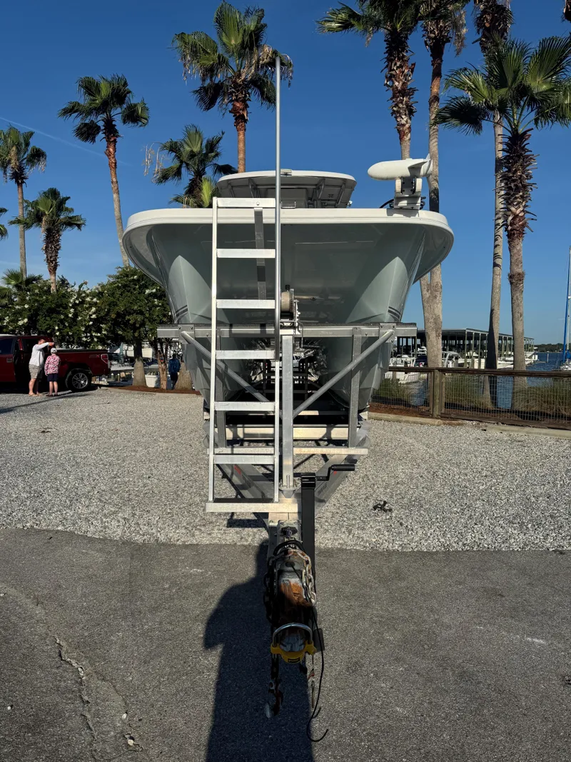 Slide: The Image of 2022 Twin Vee 310 CC GF Classic boat on trailer, surrounded by palm trees. - 3
