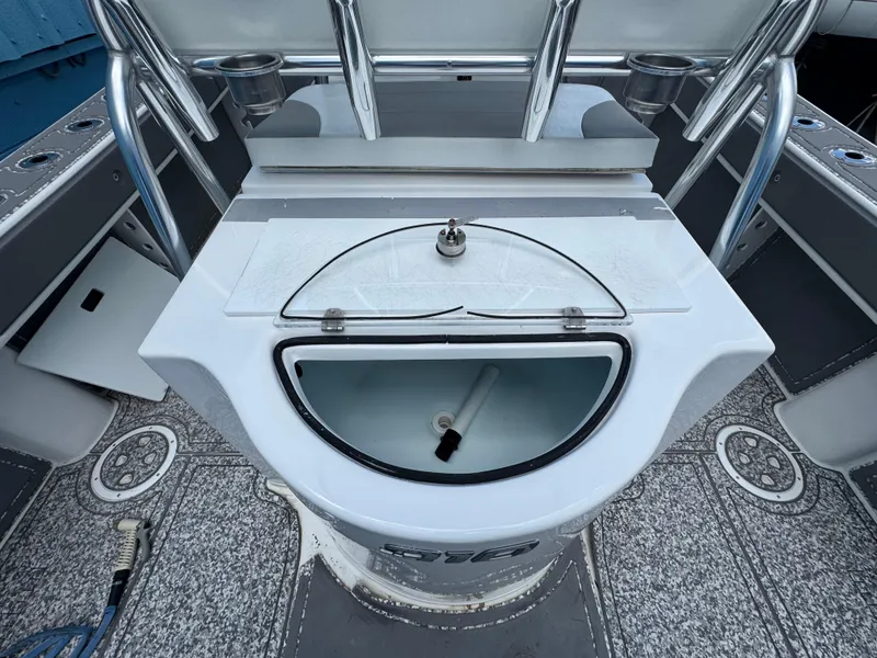 Slide: The Image of 2022 Twin Vee 310 CC GF Classic boat interior with livewell and rod holders. - 9