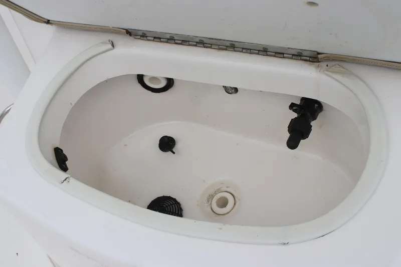Slide: The Image of Livewell compartment on a 2017 Sea Fox 220 Viper boat, featuring drainage and fittings. - 17