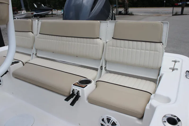 Slide: The Image of 2017 Sea Fox 220 Viper boat seating with beige cushions and cup holders. - 25