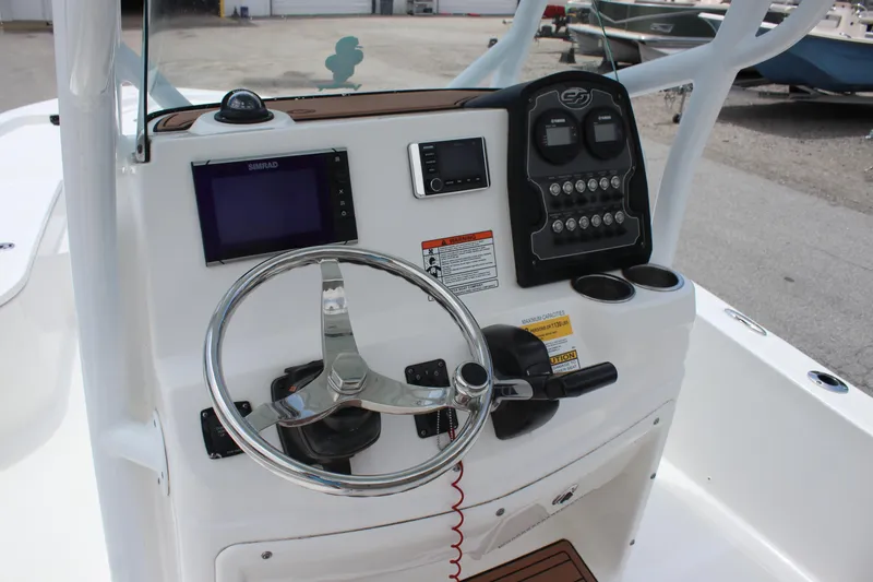 Slide: The Image of 2017 Sea Fox 220 Viper boat console with steering wheel and navigation controls. - 28