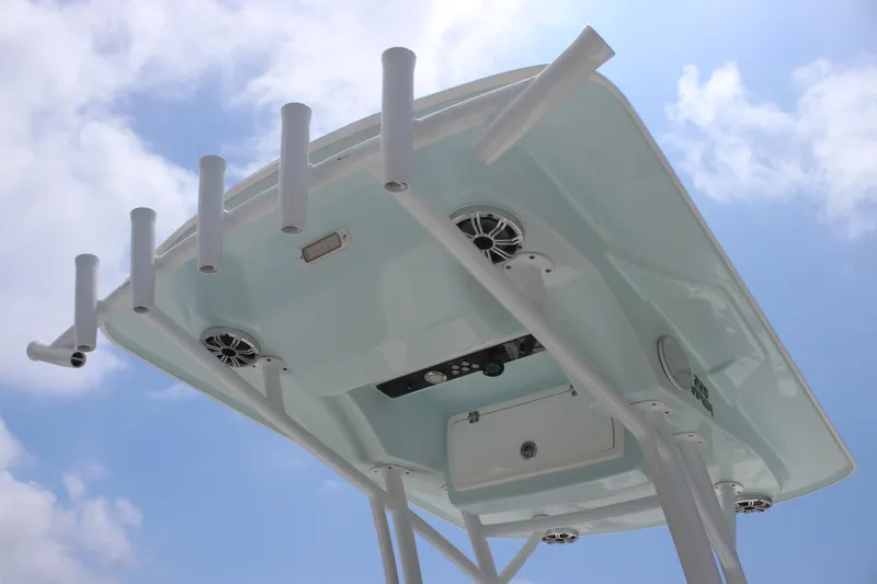 Slide: The Image of 2017 Sea Fox 220 Viper boat top view with rod holders and speakers against blue sky. - 29