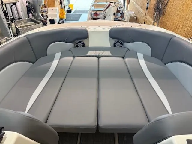 Slide: The Image of 2023 NauticStar 223 DC boat interior with gray cushioned seating and speakers. - 11