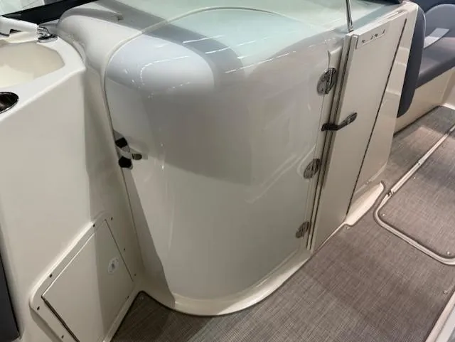 Slide: The Image of 2023 NauticStar 223 DC boat interior with sleek white cabinetry and modern design. - 12