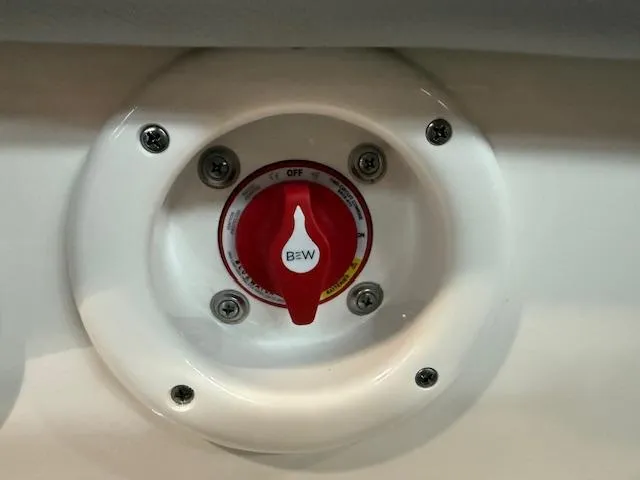 Slide: The Image of Battery switch on 2023 NauticStar 223 DC boat, featuring a red handle and white base. - 14