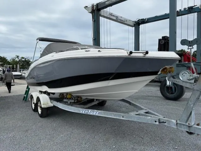 Slide: The Image of 2023 NauticStar 223 DC boat on trailer at marina. - 2