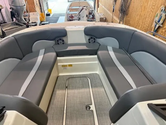 Slide: The Image of 2023 NauticStar 223 DC boat interior with gray seating and speakers. - 8