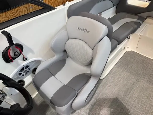 Slide: The Image of 2023 NauticStar 223 DC boat interior with gray seating and modern design. - 9