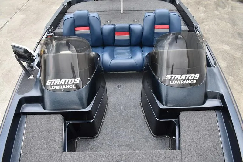 Slide: The Image of 1997 Stratos 282 DC boat interior with dual consoles and blue seating. - 15