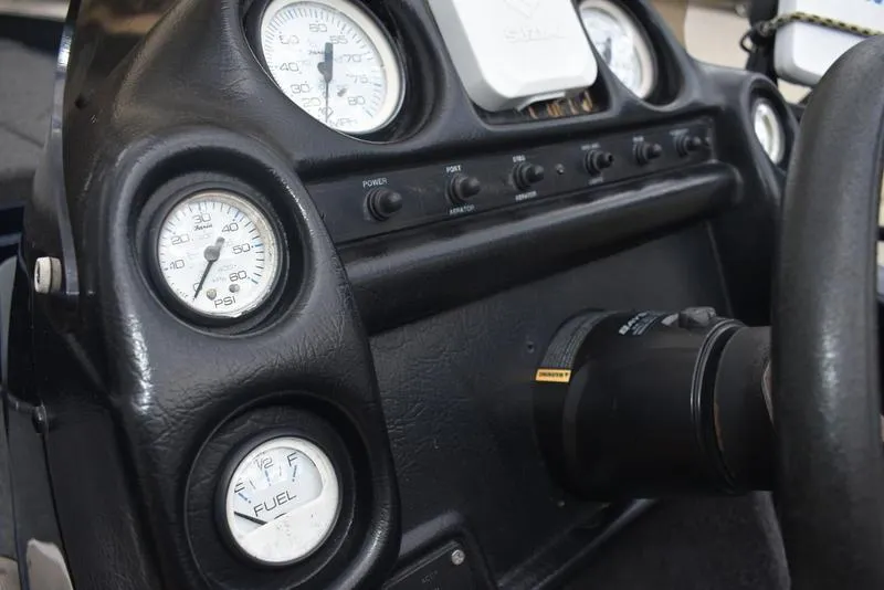 Slide: The Image of Dashboard of a 1997 Stratos 282 DC boat with gauges and controls. - 17