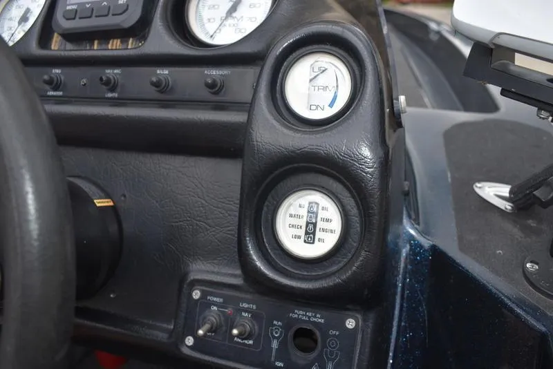 Slide: The Image of Dashboard of a 1997 Stratos 282 DC boat with gauges and controls. - 19