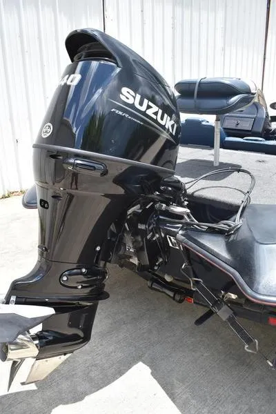 Slide: The Image of Outboard motor on a 1997 Stratos 282 DC boat, featuring a Suzuki engine. - 2