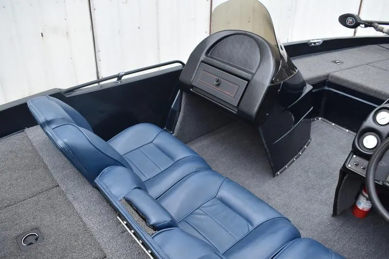 Slide: The Image of 1997 Stratos 282 DC boat interior with blue seating and dashboard controls. - 22