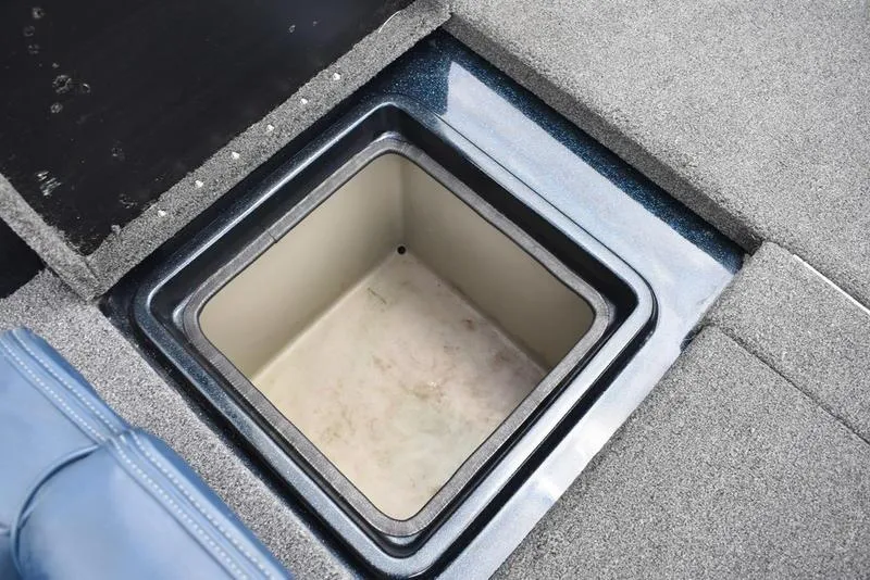Slide: The Image of Storage compartment in 1997 Stratos 282 DC boat, featuring carpeted interior and open hatch. - 24