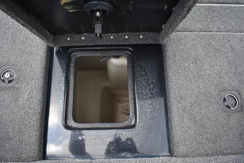 Slide: The Image of Open storage compartment on 1997 Stratos 282 DC boat, featuring carpeted interior. - 25