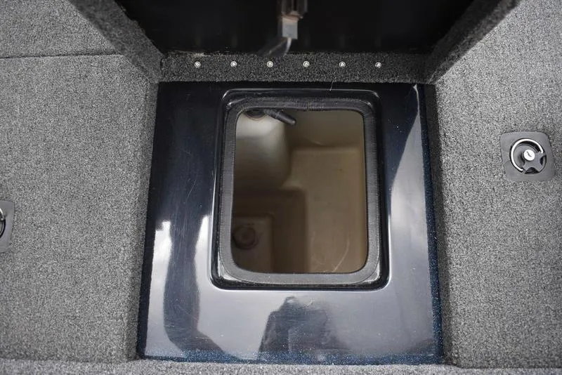 Slide: The Image of Open storage compartment in 1997 Stratos 282 DC boat, featuring carpeted interior. - 26