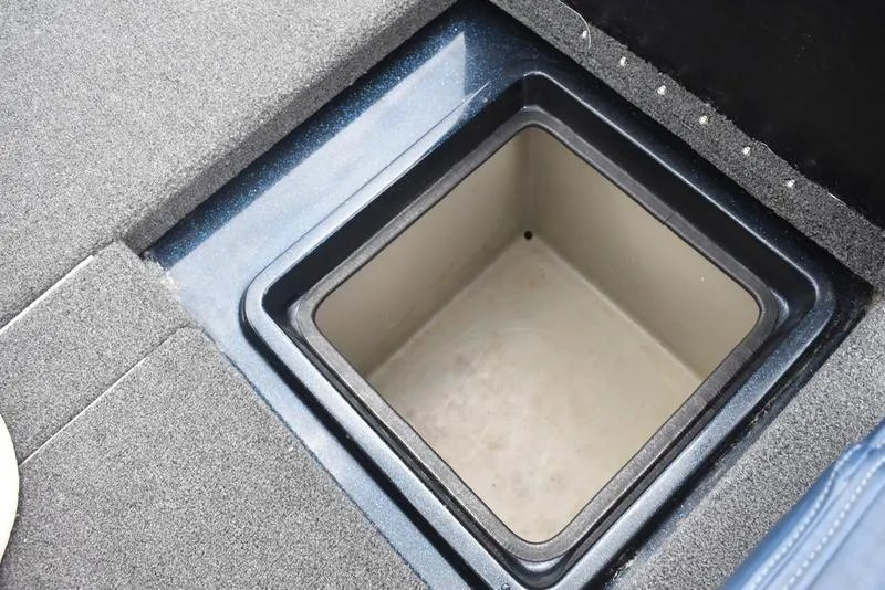 Slide: The Image of Storage compartment in 1997 Stratos 282 DC boat, featuring a square, recessed design. - 27