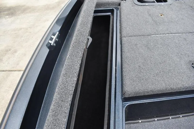 Slide: The Image of 1997 Stratos 282 DC boat storage compartment with open lid, showcasing interior space. - 8