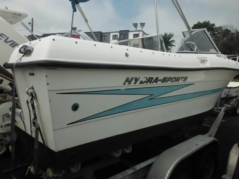 Slide: The Image of 1996 Hydra-Sports 2000 DC boat on trailer, white with blue accents. - 11