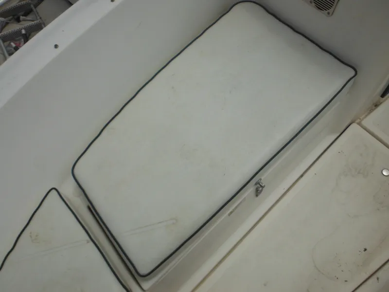 Slide: The Image of 1996 Hydra-Sports 2000 DC boat interior with cushioned seating and storage compartment. - 16