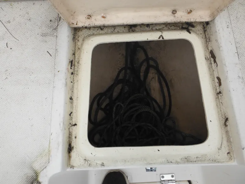 Slide: The Image of Open storage compartment with black rope on a 1996 Hydra-Sports 2000 DC boat. - 19