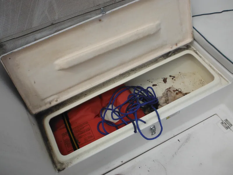 Slide: The Image of Open storage compartment on 1996 Hydra-Sports 2000 DC boat with rope and life jacket. - 21