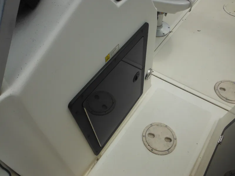 Slide: The Image of 1996 Hydra-Sports 2000 DC boat interior with storage compartment and seating. - 27