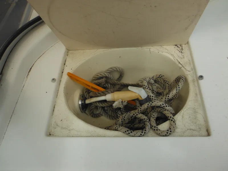 Slide: The Image of Open storage compartment on 1996 Hydra-Sports 2000 DC boat with rope and tools. - 30