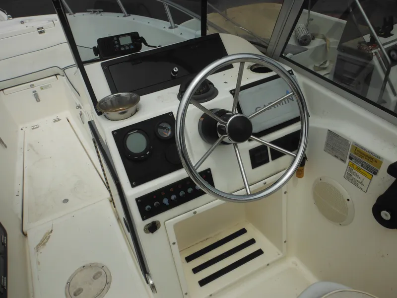 Slide: The Image of 1996 Hydra-Sports 2000 DC boat dashboard with steering wheel and navigation instruments. - 33