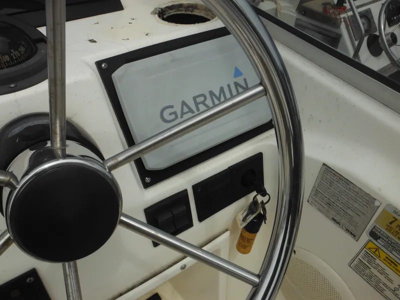 Slide: The Image of Steering wheel and Garmin display on 1996 Hydra-Sports 2000 DC boat dashboard. - 38