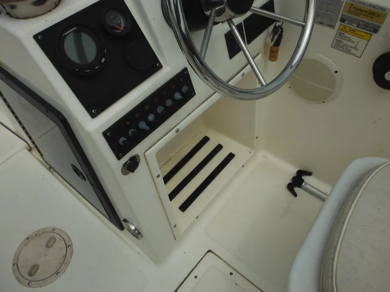 Slide: The Image of 1996 Hydra-Sports 2000 DC boat dashboard with steering wheel and control panel. - 41