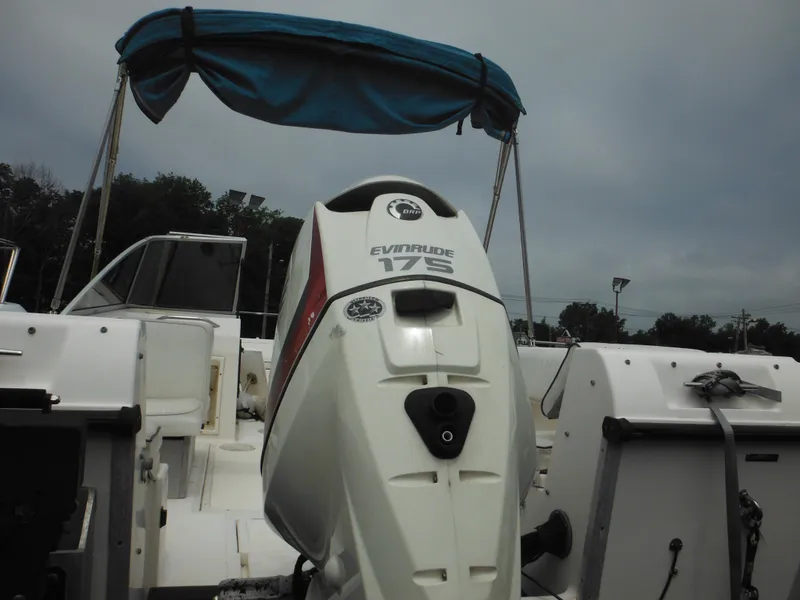 Slide: The Image of 1996 Hydra-Sports 2000 DC boat with Evinrude 175 outboard motor, blue canopy, overcast sky. - 6