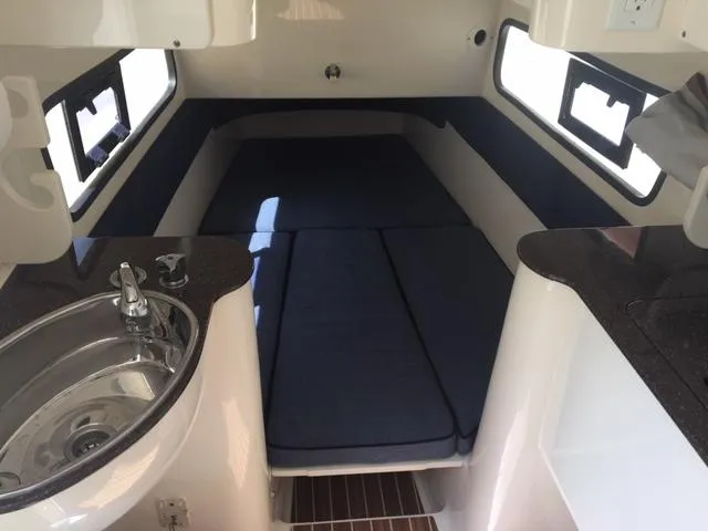 Slide: The Image of 2016 Scout 350 LXF cabin interior with bed, sink, and windows. - 15