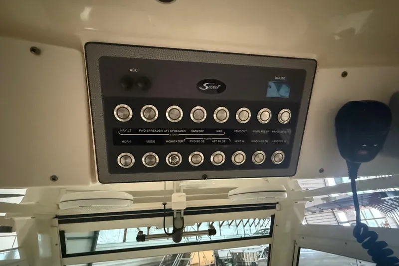 Slide: The Image of Control panel of a 2016 Scout 350 LXF boat with various switches and microphone. - 22