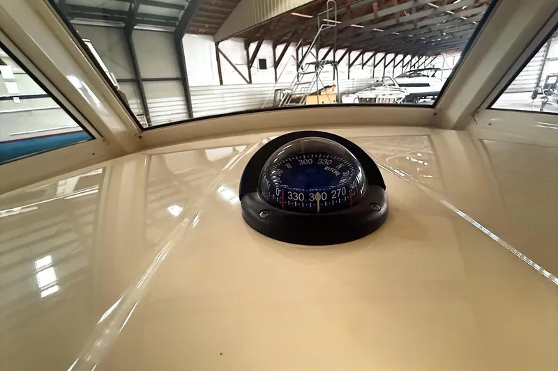 Slide: The Image of Compass on 2016 Scout 350 LXF boat dashboard in a marina setting. - 23