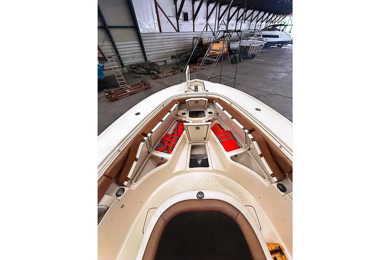 Slide: The Image of 2016 Scout 350 LXF boat interior with seating and storage in a warehouse. - 25