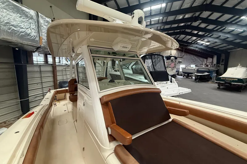 Slide: The Image of 2016 Scout 350 LXF boat in indoor storage, showcasing sleek design and luxury seating. - 27