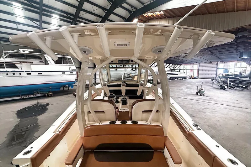 Slide: The Image of 2016 Scout 350 LXF boat interior in a spacious indoor marina setting. - 28