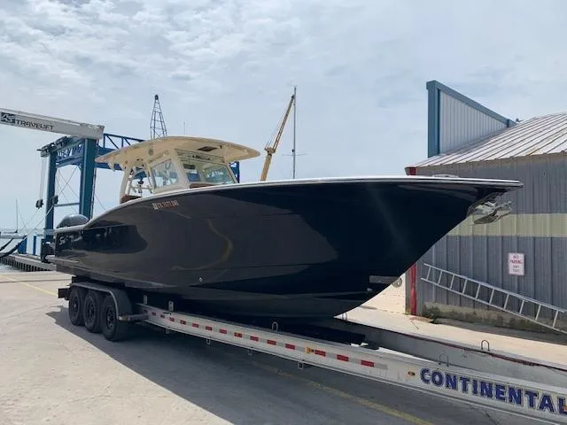 Slide: The Image of 2016 Scout 350 LXF boat on trailer at marina, ready for launch. - 3