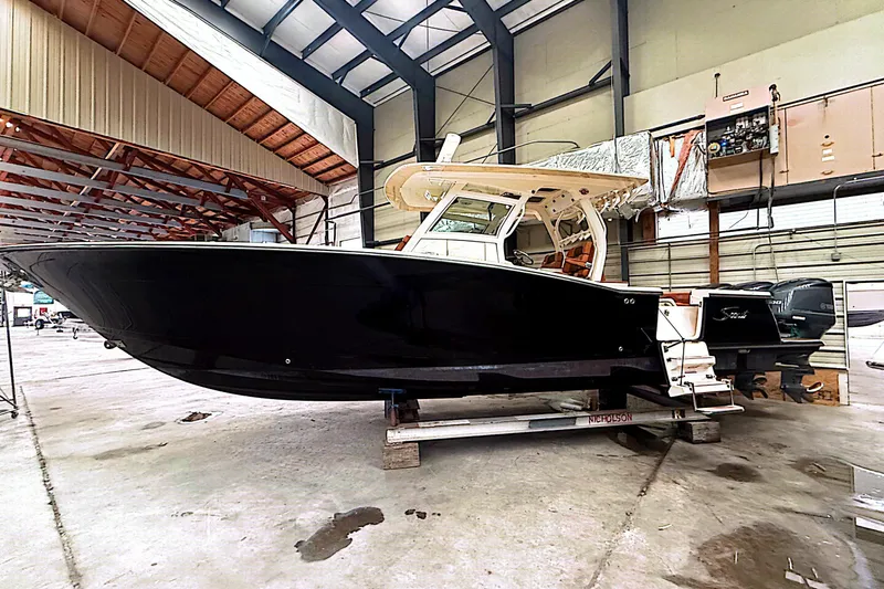 Slide: The Image of 2016 Scout 350 LXF boat in a spacious indoor storage facility. - 33