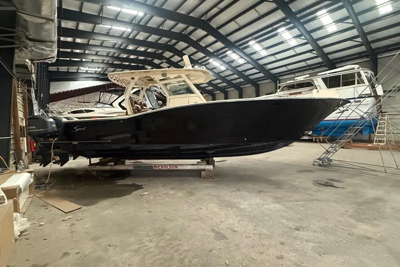 Slide: The Image of 2016 Scout 350 LXF boat in a spacious indoor storage facility. - 34