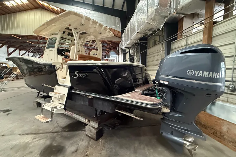 Slide: The Image of 2016 Scout 350 LXF boat with Yamaha outboard engine in a warehouse setting. - 35