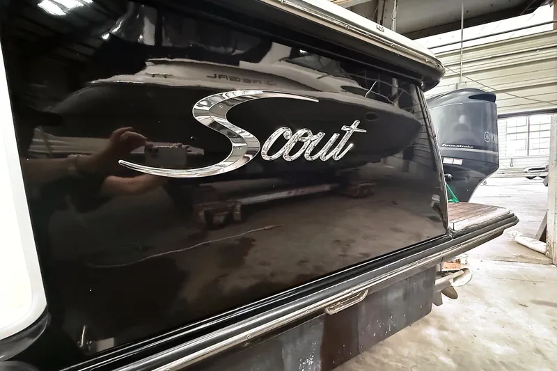 Slide: The Image of 2016 Scout 350 LXF boat with reflective black finish in a storage facility. - 36