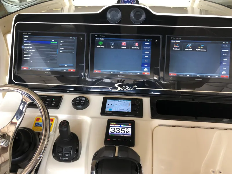 Slide: The Image of 2016 Scout 350 LXF boat dashboard with advanced navigation screens and controls. - 5