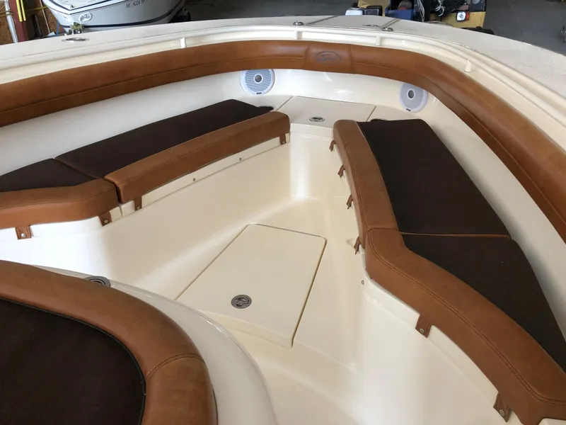 Slide: The Image of 2016 Scout 350 LXF boat interior with brown cushioned seating and speakers. - 6